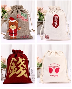 Detailed view of four burlap drawstring gift bags with Christmas and festive printed patterns