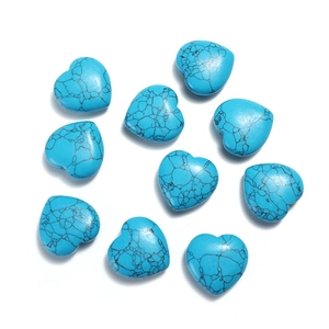 Top-down view of ten heart-shaped blue turquoise loose beads with natural black veins