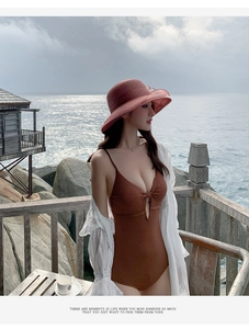 Close-up of a women's brown organza sun hat with flower detail for beach vacation