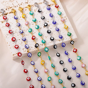 Detail of colorful enamel Evil Eye bracelets with gold and silver plating on a stone surface