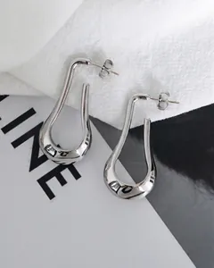 Detailed view of silver teardrop earrings with high-polish mirror finish in minimalist style