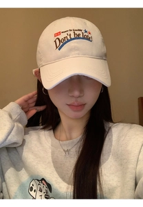 Detailed embroidery text on a cream cotton baseball cap with vintage American style