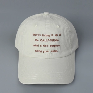 Detail of premium cotton twill baseball cap with brown letter embroidery and fabric texture