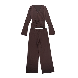 Detail of dark brown knit two-piece lounge set with V-neck long sleeve top and wide leg pants