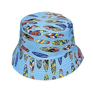 Sky blue bucket hat with colorful surfboard prints and The Ocean Calling text embroidery