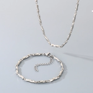 Detailed view of silver stainless steel chopin chain necklace and bracelet with lobster clasp