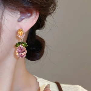 Close-up of model wearing flower drop earring with colorful zircon and gold finish