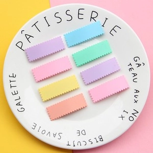 Set of 8 pastel macaron wave-edge hair clips displayed on a white ceramic plate