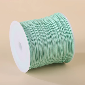 0.8mm mint green nylon cord on white spool for handcrafted jewelry and necklaces