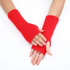 Close-up of red striped knit arm warmers with thumb holes on model arms
