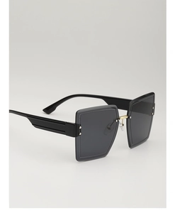 Detail view of square oversized sunglasses with wavy gold metal temples and dark lenses