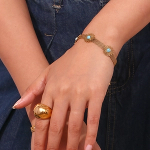 Detail showing 18K gold-plated sunflower bracelet with turquoise and round polished ring