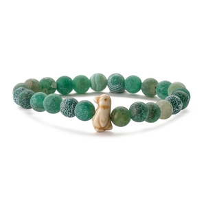 Detailed view of green round beaded bracelet featuring a cute penguin charm on white background