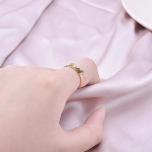 Polished gold stainless steel adjustable ring featuring cursive 'mama' artistic design