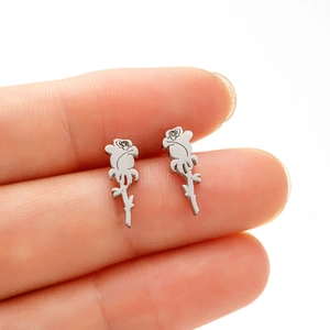 Macro shot of silver rose stud earrings showing intricate petals and stem details