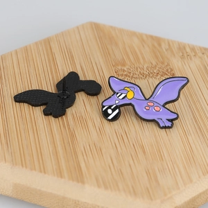 Detail of cute purple dinosaur enamel pin with sunglasses and headphones, front and back view