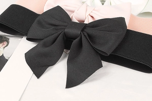Detail of wide elastic waist belts with large bow decorations in various colors
