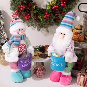 Christmas snowman and Santa gnome plush dolls with colorful knitted hats and Merry Christmas bags