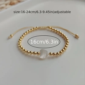 Adjustable gold bead bracelet with white heart shell showing 16-24cm size range
