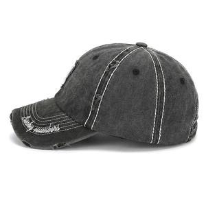 Detailed macro of vintage washed baseball cap with Lucky Numbers embroidery and distressed edges