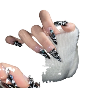 Stiletto handmade nails with gothic black and white marble patterns and blue stars