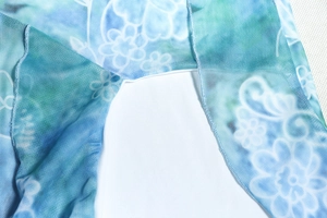Detail of blue and green floral print on breathable mesh fabric with quality stitching
