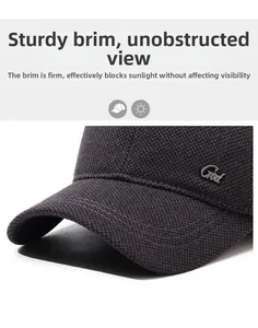 Detail of grey winter baseball cap showing thick woven texture and metal side logo