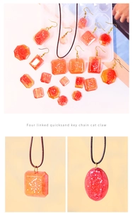 Macro shot of red-orange gradient resin pendants and earrings with sparkling glitter flakes