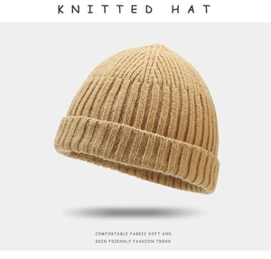 Detail of khaki knitted beanie showing tight ribbed texture and soft skin-friendly fabric