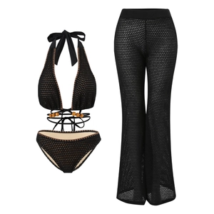 Detail of black crochet bikini set with beaded straps and mesh wide-leg cover-up trousers