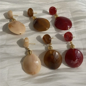 Vintage resin drop earring set in amber, cream, and ruby red with gold metal finish