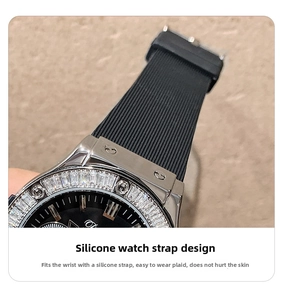 Macro detail of luxury silver watch case with gemstone bezel and black silicone strap