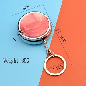 Portable round metal medicine pill box keychain with orange marble texture lid design