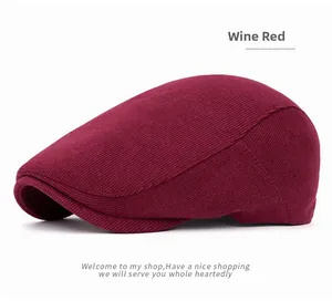 Detailed close-up of wine red corduroy newsboy cap showing fine knitted texture and seams