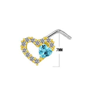 Detailed macro view of a 7mm L-shaped gold nose stud with blue heart-shaped zircon stone