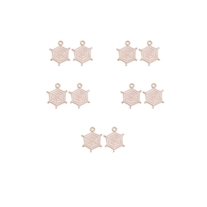 Detail view of ten gold-rimmed white enamel spider web charms for jewelry making