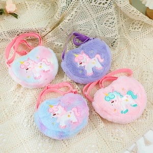 Flat lay of colorful plush heart-shaped unicorn crossbody bags for little girls