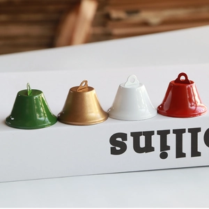 Set of colorful metal Christmas bell ornaments in green gold white and red finish