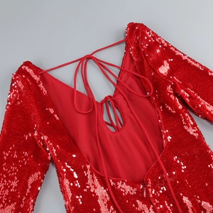 Detail of red sequin dress showing backless cutout and lace-up strap design