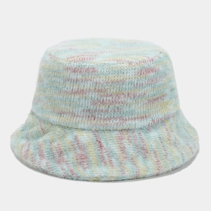 Detailed close-up of blue knit bucket hat with fluffy texture and colorful stripes