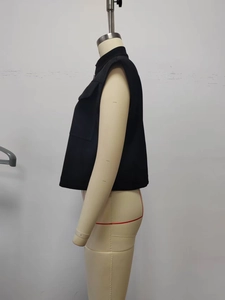 Side view of black sleeveless vest featuring stand-up collar and utility cargo pockets