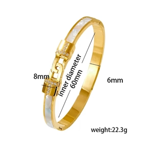 Macro view of gold stainless steel T-bracelet with zircon inlay and size dimensions