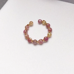Macro detail of handmade 14K gold filled wire wrapped colorful tourmaline bead ring