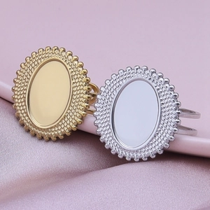 Detailed view of DIY oval ring bases in gold and silver steel on purple silk