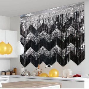 Detail of silver and black wavy foil fringe curtain for festive party background wall