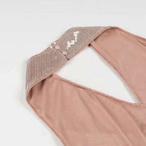 Detail of sequin floral embroidery and halter neck closure on the pink party dress
