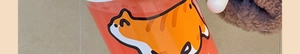 Close-up of a high borosilicate glass tea cup with a cute orange cat illustration