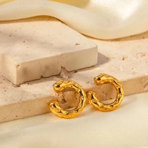 18K gold plated stainless steel C-shape earrings with hammered texture on silk background