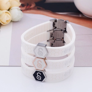 White silicone magnetic energy bracelet with honeycomb texture and hexagonal metal accents