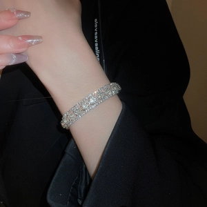 Macro shot of silver-tone wide cuff bracelet with multi-layer pave-set floral diamonds